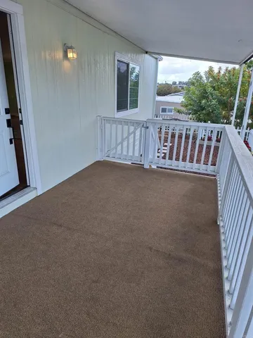 a view of balcony with furniture