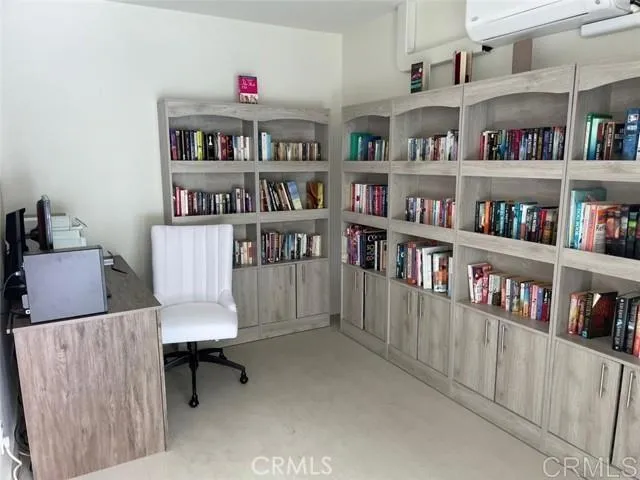 a living room with lots of books