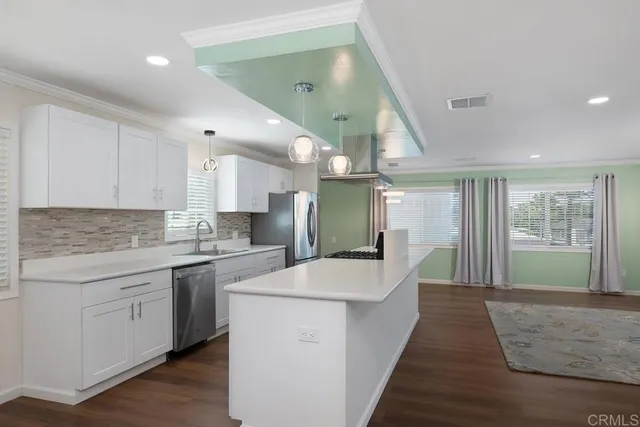 a large kitchen with kitchen island a sink stainless steel appliances and cabinets