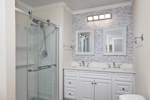 a bathroom with a shower sink and mirror