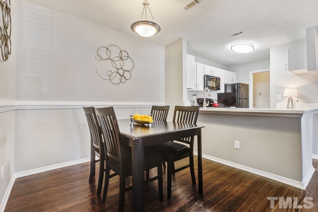 2701 Homestead Road, Unit B1 Chapel Hill, NC 27516 - Photo 13 of 25 a view of a dining room with furniture and wooden floor