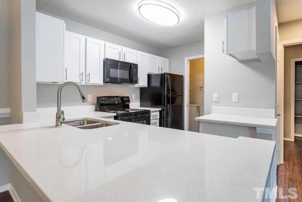2701 Homestead Road, Unit B1 Chapel Hill, NC 27516 - Photo 14 of 25 a kitchen with stainless steel appliances a refrigerator sink and microwave