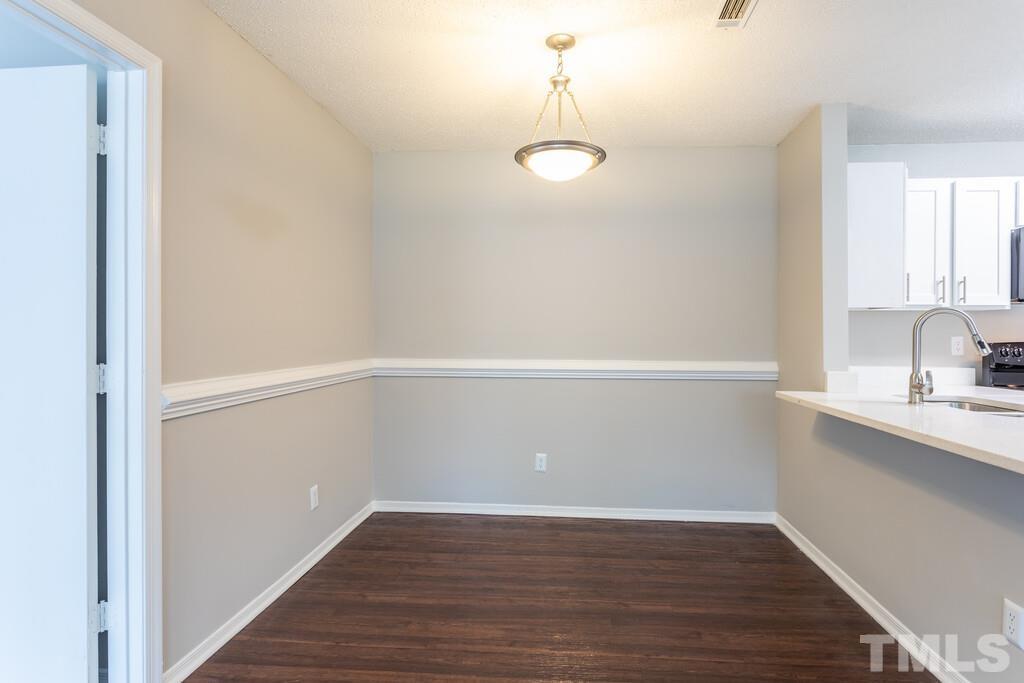 2701 Homestead Road, Unit B1 Chapel Hill, NC 27516 - Photo 16 of 25 a view of a kitchen with wooden floor and cabinets