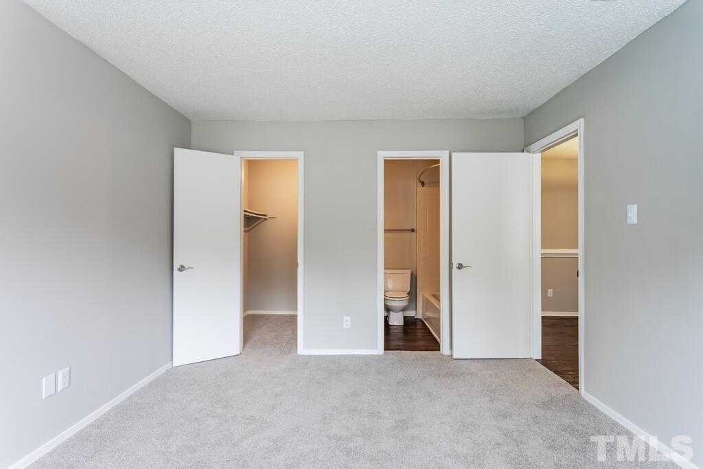 2701 Homestead Road, Unit B1 Chapel Hill, NC 27516 - Photo 21 of 25 an empty room with closet and wooden floor