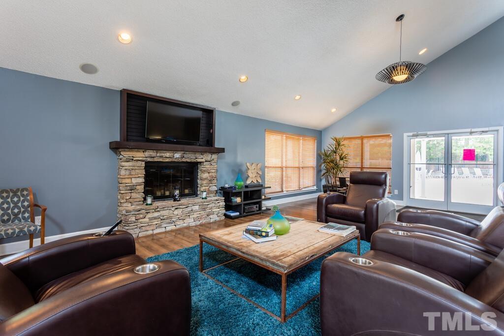 2701 Homestead Road, Unit B1 Chapel Hill, NC 27516 - Photo 8 of 25 a living room with furniture a flat screen tv and a fireplace