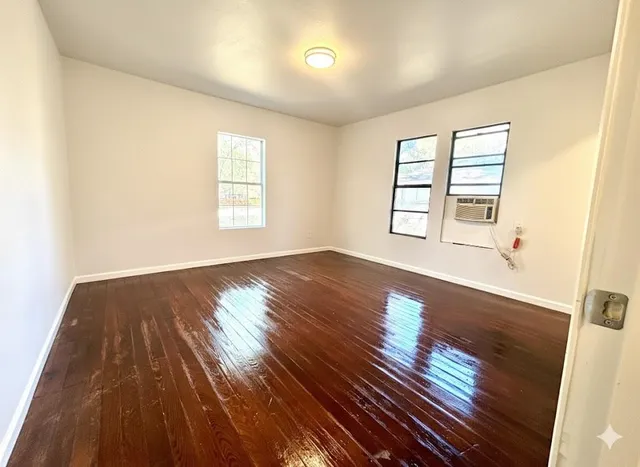 a white toilet sitting next to a bathroom sink and a mirror