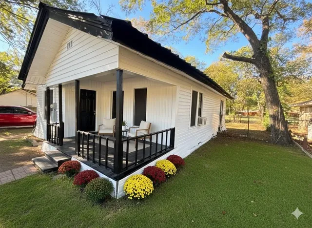 a view of house with backyard and furniture