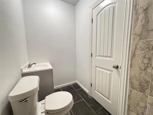 a white toilet sitting next to a shower curtain