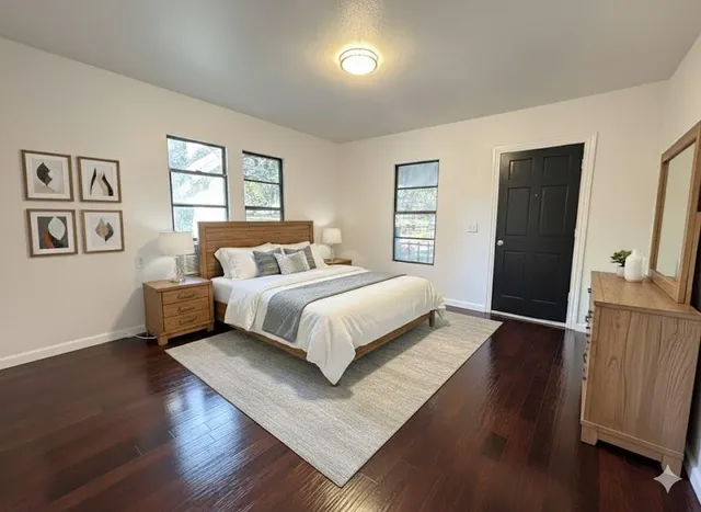 a bedroom with a bed and wooden floor