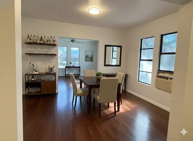 a view of a dining room with furniture window and wooden floor