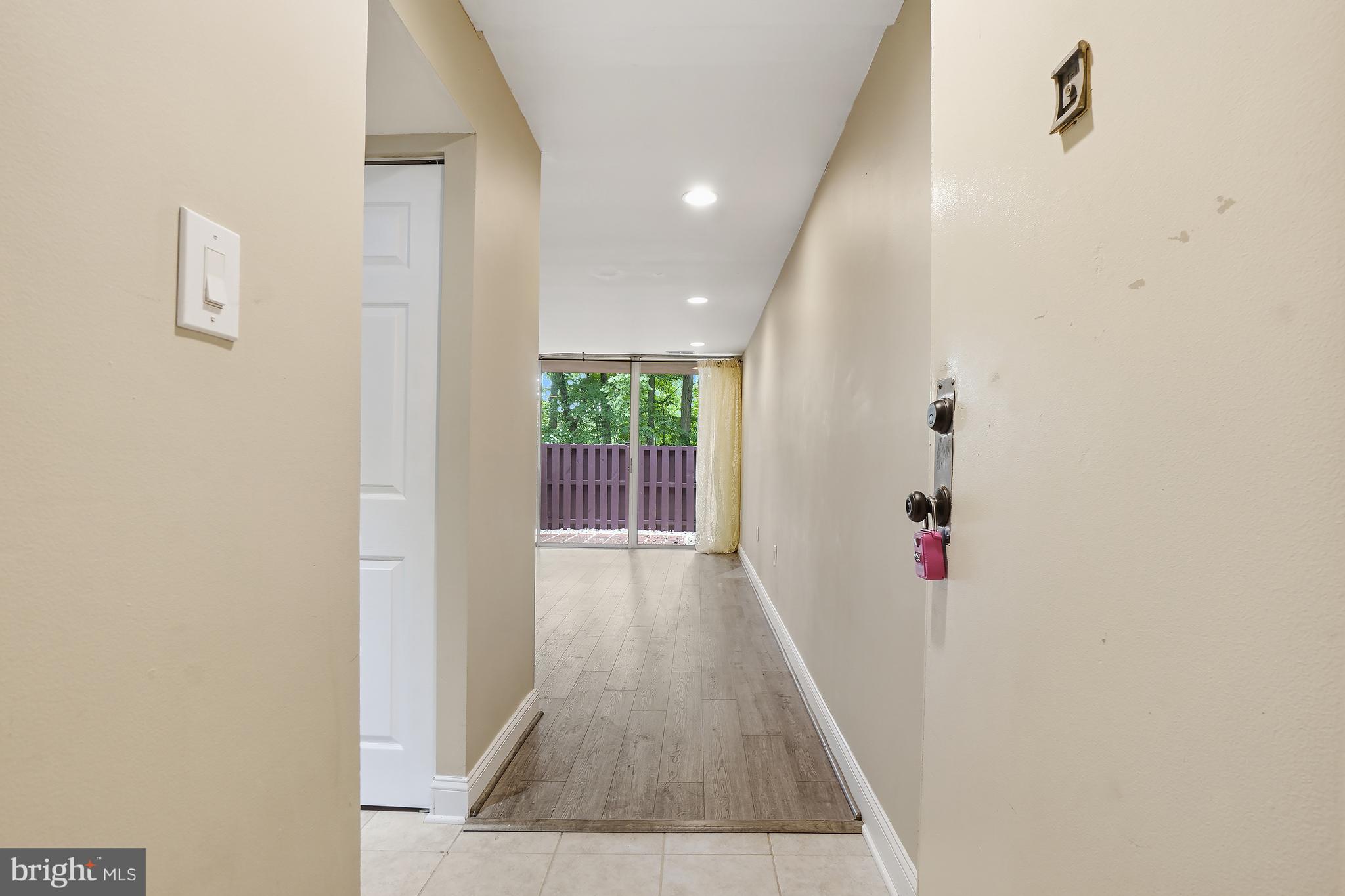 8487 Greenbelt Road Greenbelt, MD 20770 - Photo 2 of 29 a view of a hallway with wooden floor and a bathroom