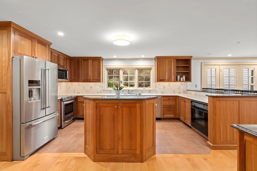 29 Cutler Road Hamilton, MA 01982 - Photo 13 of 42 a kitchen with stainless steel appliances granite countertop a refrigerator a stove a sink and a microwave