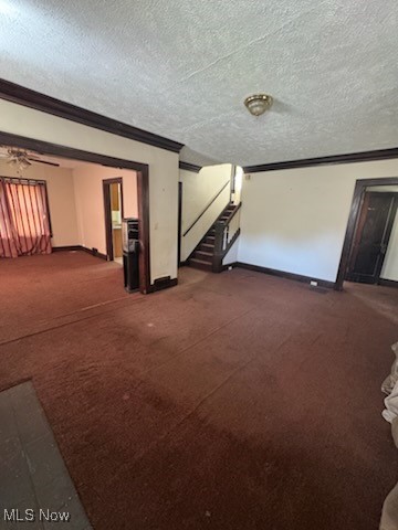 870 Helmsdale Road Cleveland Heights, OH 44112 - Photo 7 of 20 Unfurnished living room featuring dark colored carpet, a textured ceiling, stairway, a ceiling fan, and ornamental molding