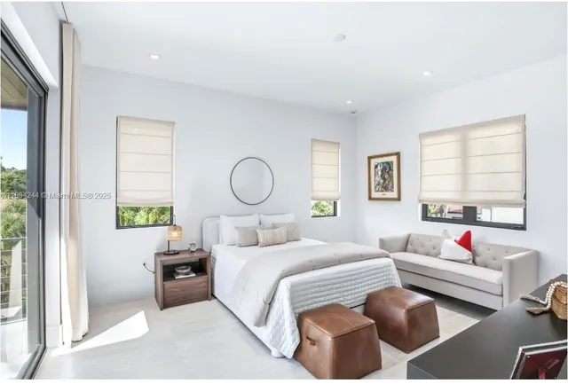 a bedroom with a bed and a large window