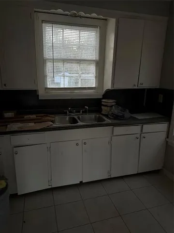 a kitchen with a cabinets and a stove top oven