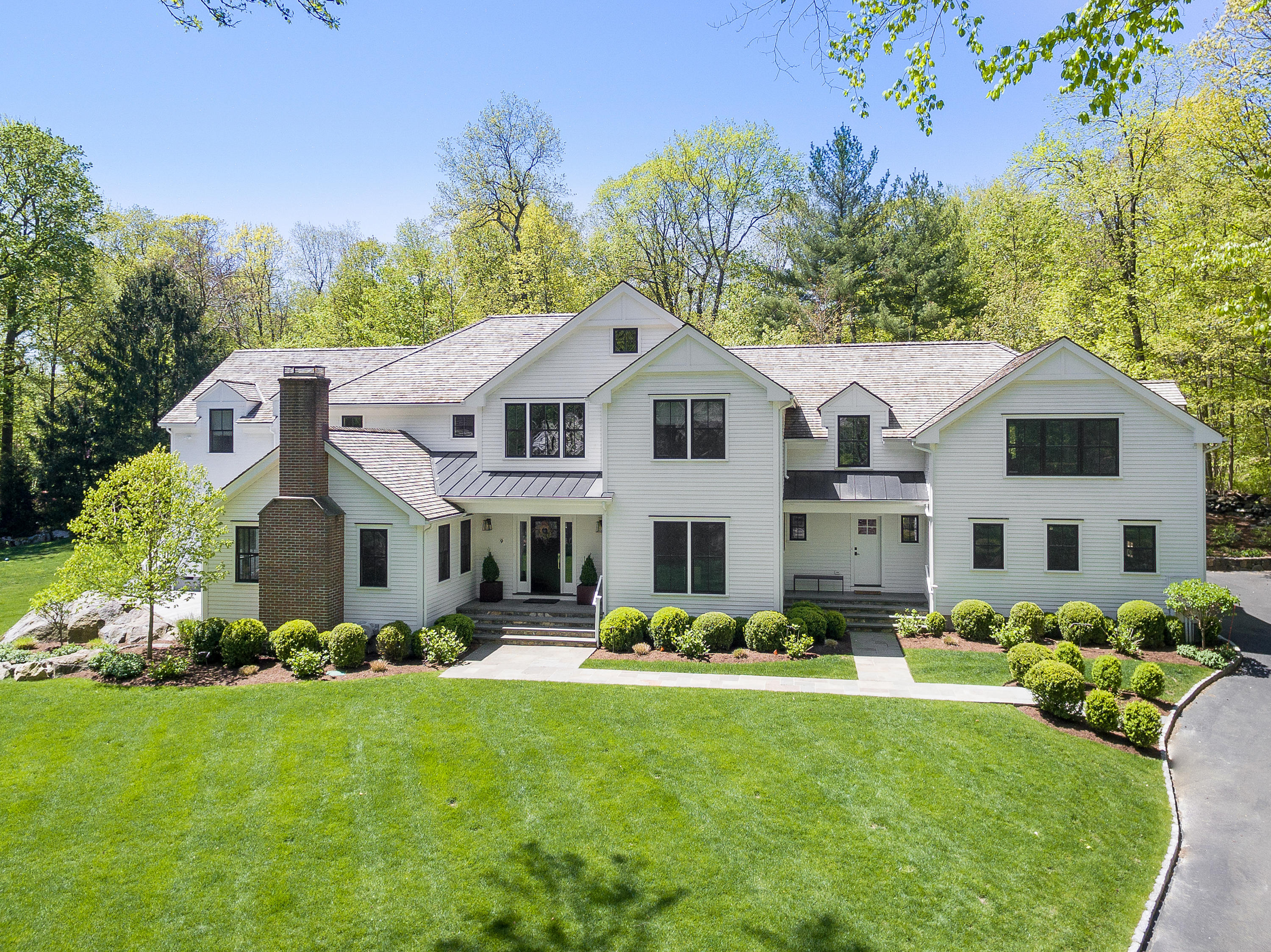9 Canoe Trail Darien, CT 06820 - Photo 2 of 28 a front view of a house with garden