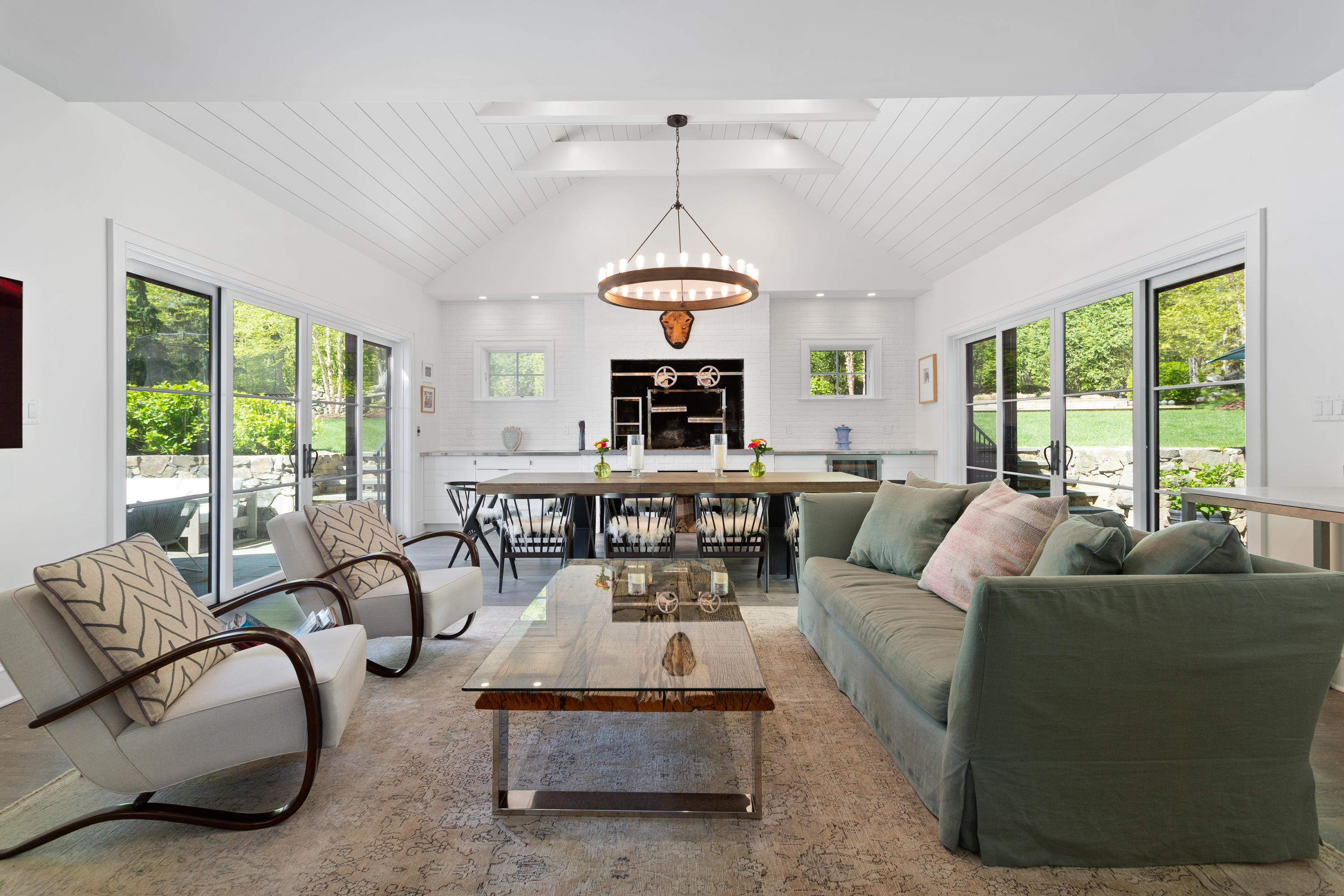 9 Canoe Trail Darien, CT 06820 - Photo 8 of 28 a living room with patio furniture and a chandelier