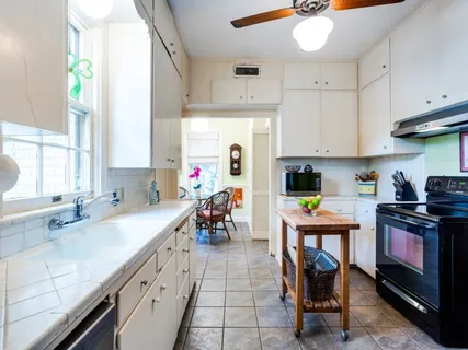 a kitchen with stainless steel appliances granite countertop a sink and a stove