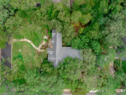 an aerial view of a house with a yard