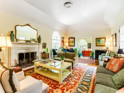 a living room with furniture fireplace and a table