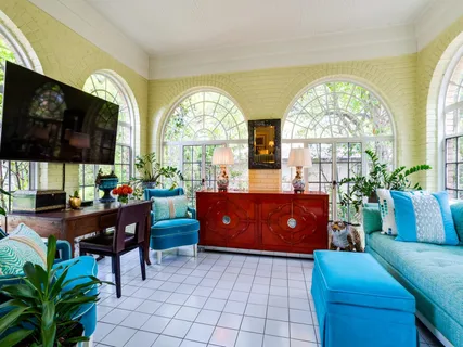 a living room filled with furniture and a flat screen tv