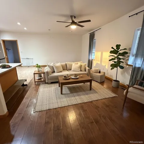 a living room with furniture and wooden floor