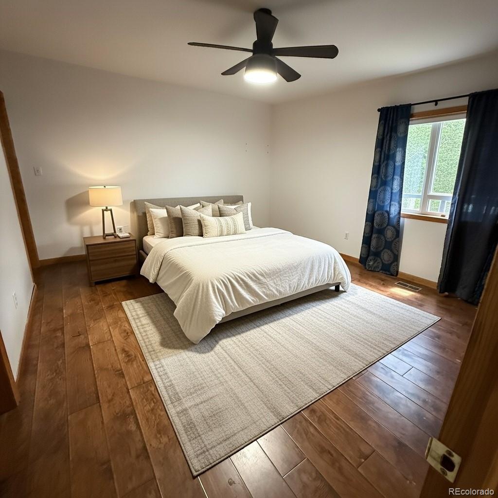 209 West Hall Street Fleming, CO 80728 - Photo 4 of 7 a bedroom with double bed and a window