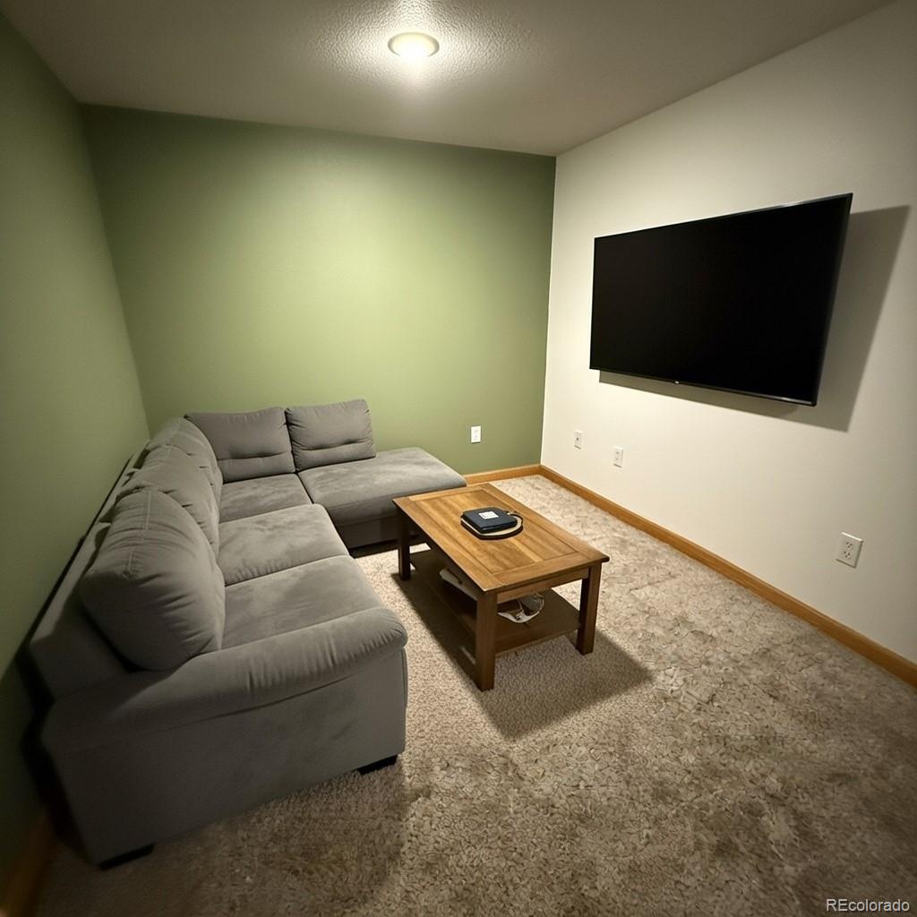 209 West Hall Street Fleming, CO 80728 - Photo 5 of 7 a living room with furniture and a flat screen tv