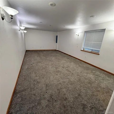 an empty room with a empty space and windows