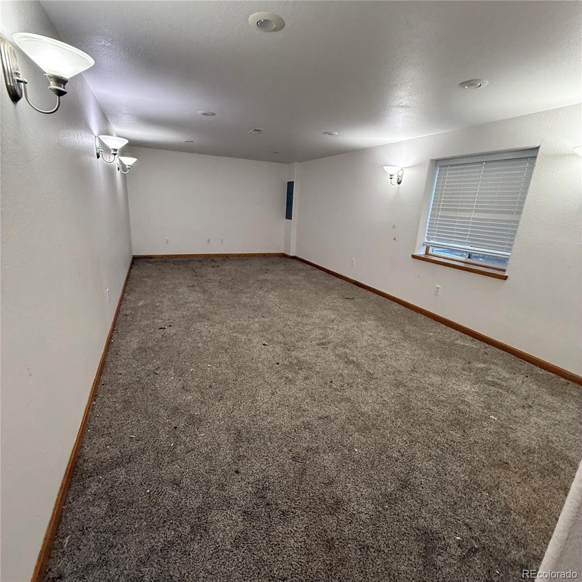 209 West Hall Street Fleming, CO 80728 - Photo 6 of 7 an empty room with a empty space and windows