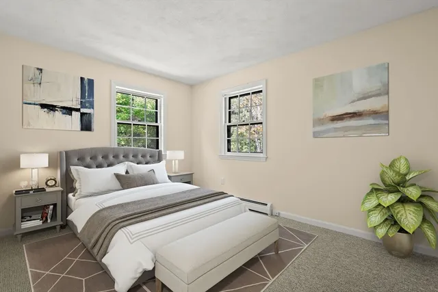 a bedroom with a bed and a painting on the wall