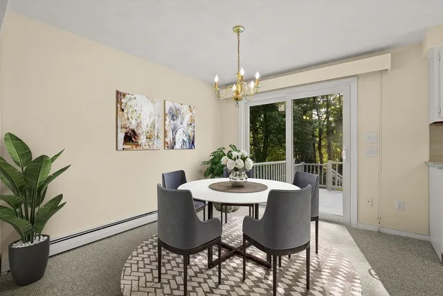 a dining room with furniture a window and a chandelier
