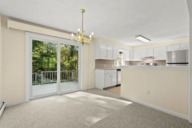a open kitchen with stainless steel appliances granite countertop a refrigerator sink and white cabinets