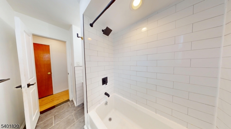 40 Howard Street, Unit 1 Bloomfield, NJ 07003 - Photo 12 of 21 a bathroom with a bathtub and a shower