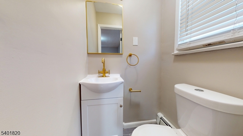 40 Howard Street, Unit 1 Bloomfield, NJ 07003 - Photo 17 of 21 a bathroom with a toilet sink and mirror