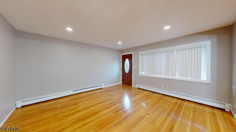 40 Howard Street, Unit 1 Bloomfield, NJ 07003 - Photo 2 of 21 a view of an empty room with wooden floor and a window