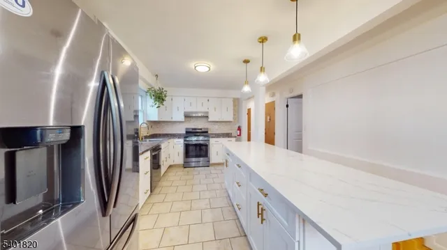 a large kitchen with cabinets and stainless steel appliances