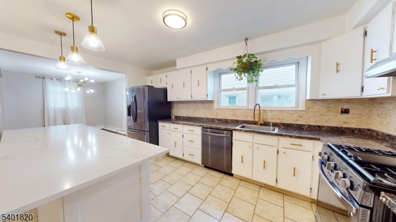 40 Howard Street, Unit 1 Bloomfield, NJ 07003 - Photo 8 of 21 a large kitchen with granite countertop a white stove top oven and cabinets