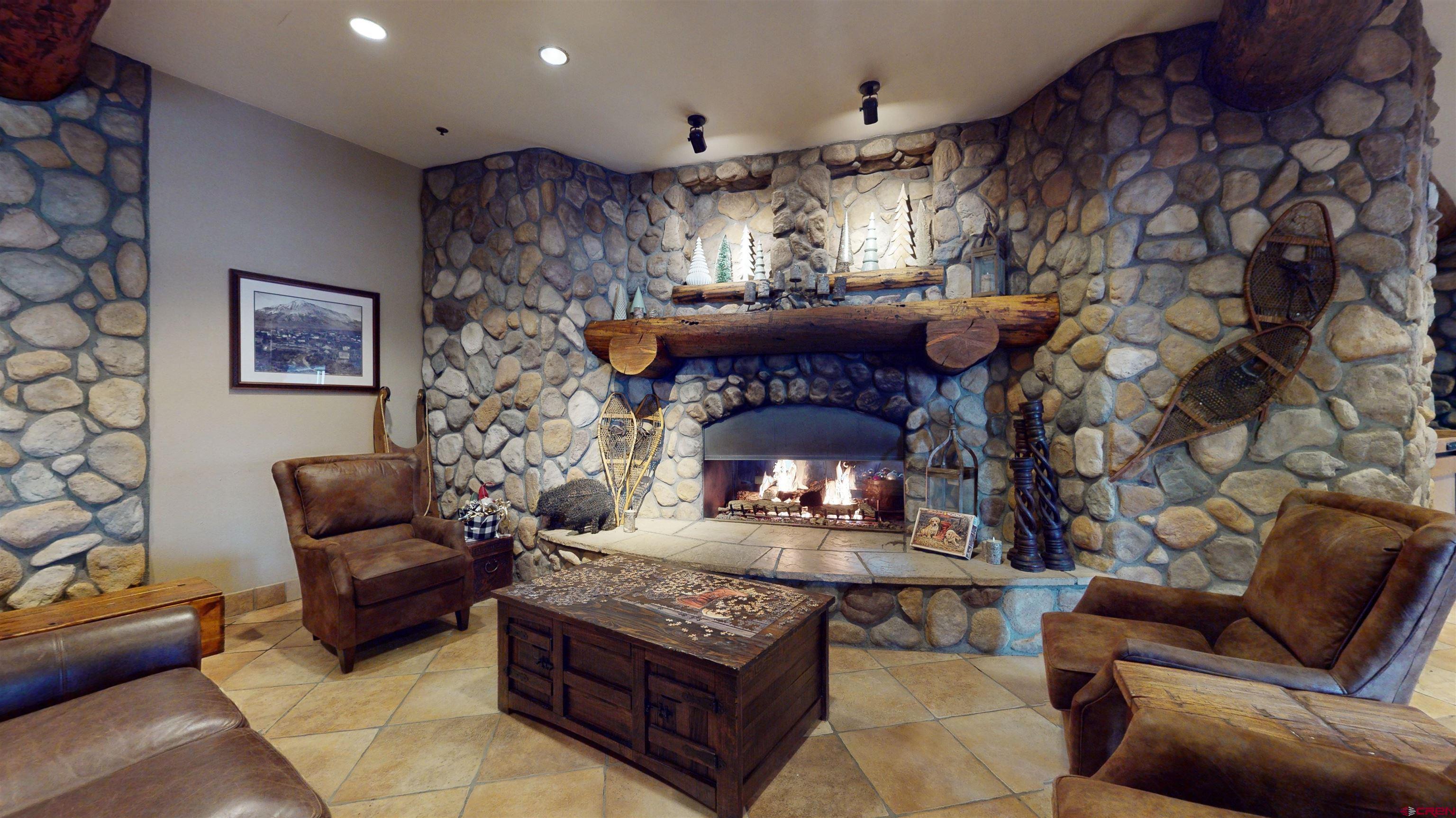 6 Emmons Road, Unit 317 Crested Butte, CO 81225 - Photo 16 of 19 a living room with furniture and a fireplace