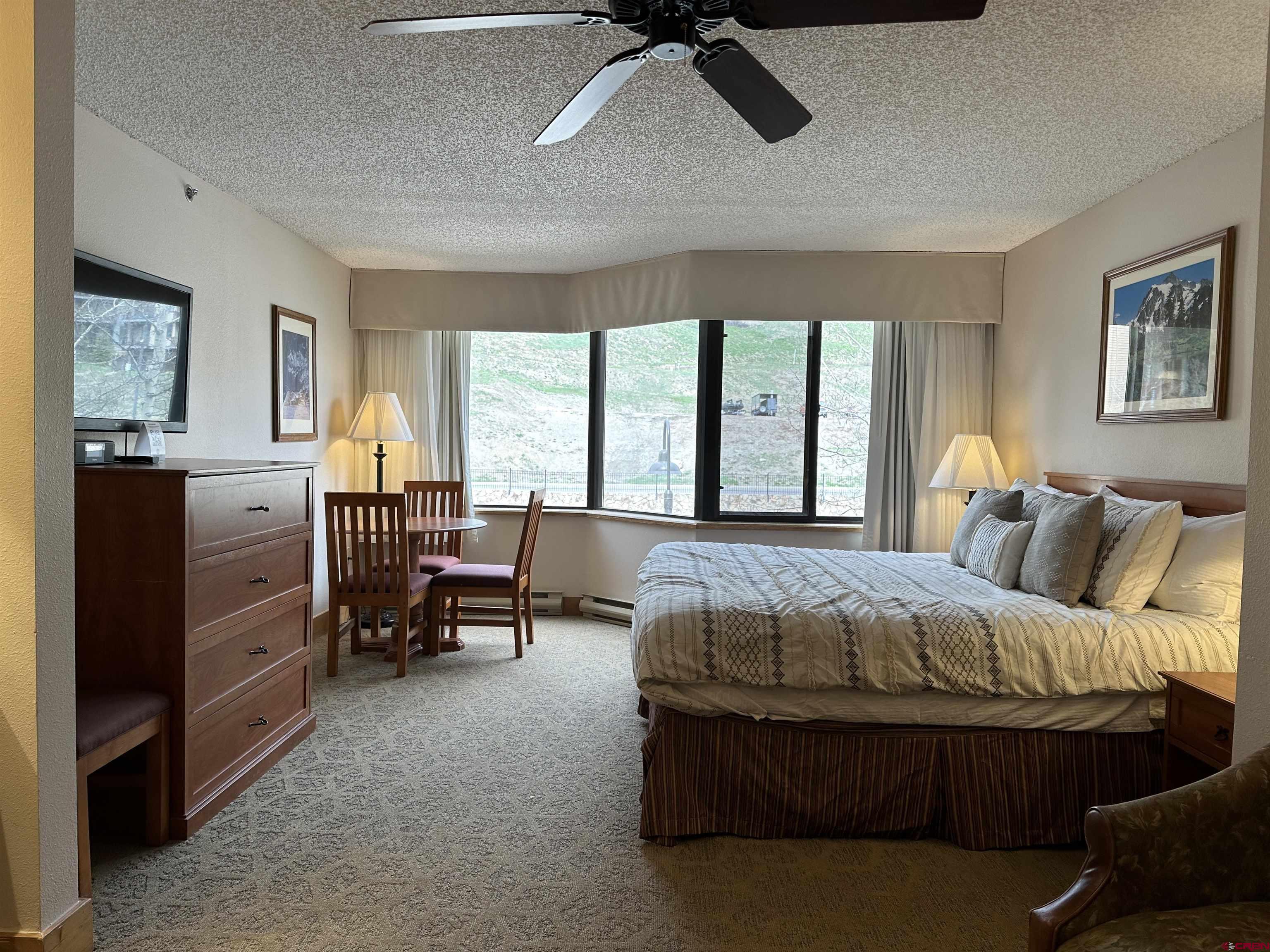 6 Emmons Road, Unit 317 Crested Butte, CO 81225 - Photo 2 of 19 a bedroom with a bed and wooden floor