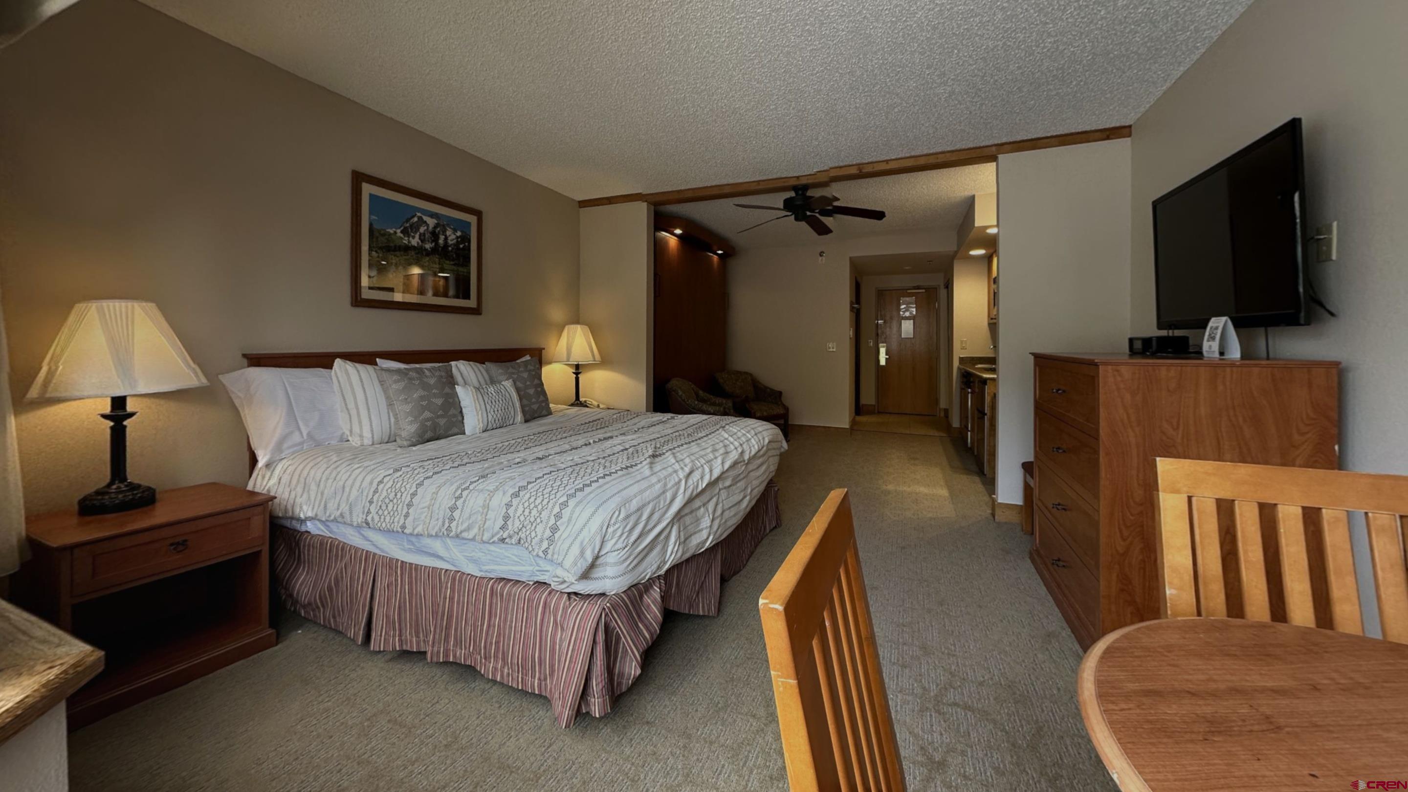 6 Emmons Road, Unit 317 Crested Butte, CO 81225 - Photo 5 of 19 a bedroom with a bed and a flat screen tv