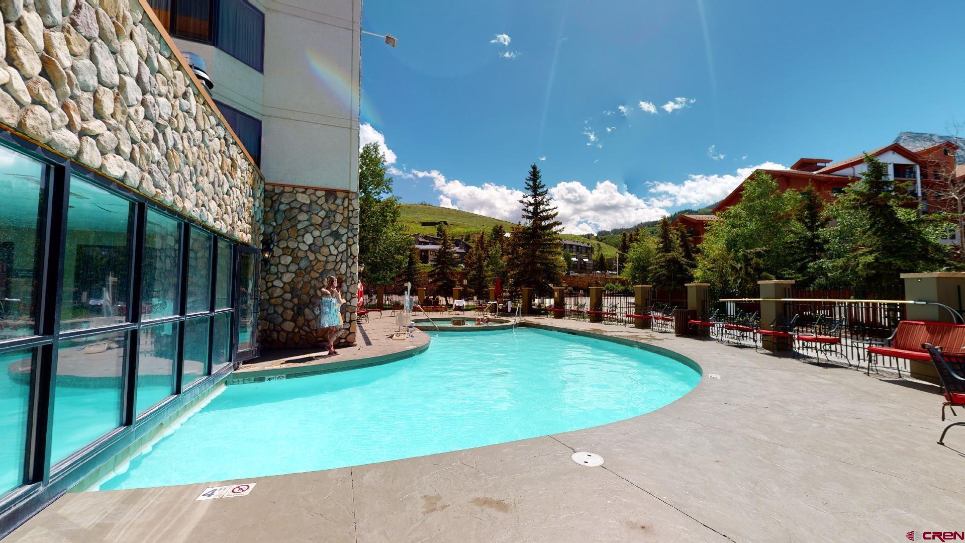 6 Emmons Road, Unit 317 Crested Butte, CO 81225 - Photo 10 of 19 a view of a swimming pool with a patio and a yard