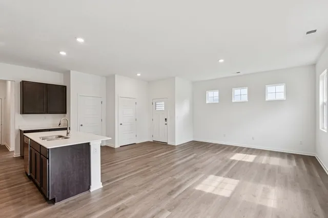 a view of room with wooden floor and flat screen tv