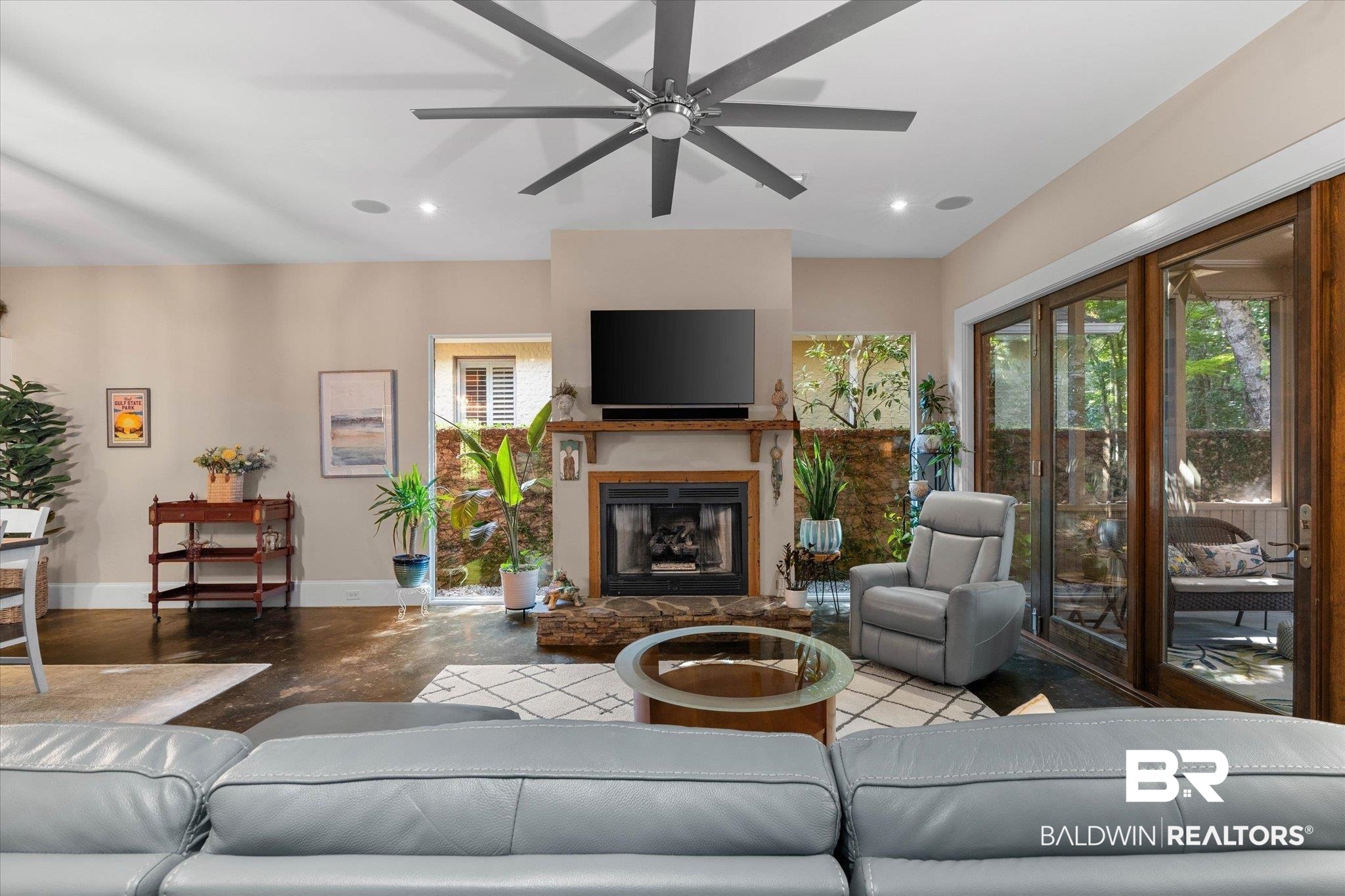 3400 Rue Royal Mobile, AL 36693 - Photo 8 of 33 Living room featuring recessed lighting, a glass covered fireplace, and a ceiling fan