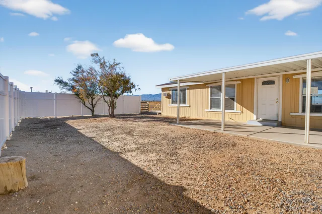 a view of a house with a backyard