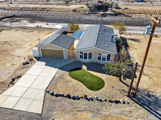 an aerial view of a house with a yard