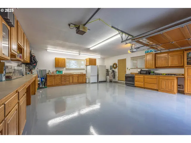 a open kitchen with cabinets and flat screen tv