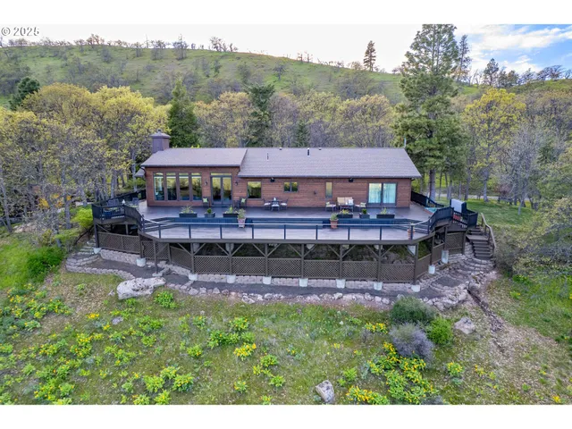 an aerial view of a house with big yard