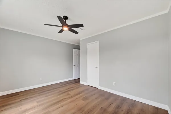 a view of empty room with wooden floor