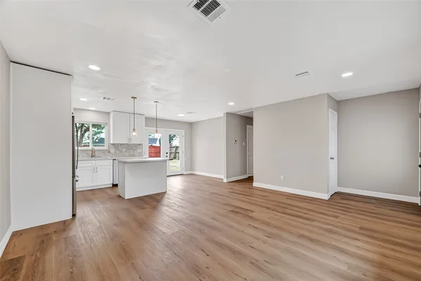 a view of kitchen and wooden floor